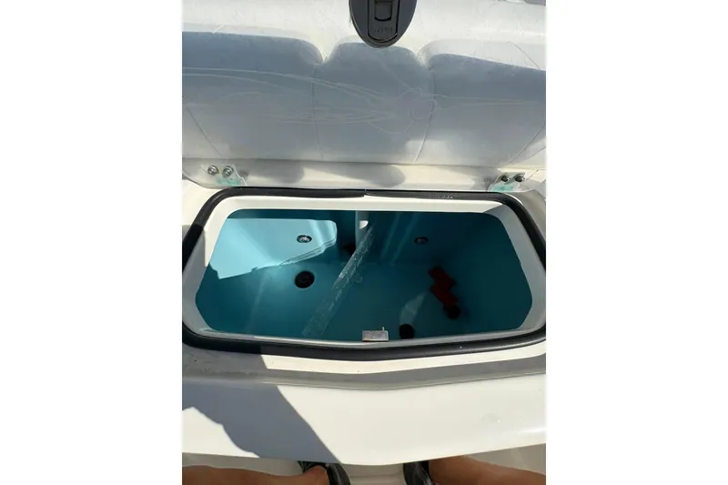 Slide: The Image of 2023 Skeeter SX2550 Family boat livewell, open lid, blue interior. - 9