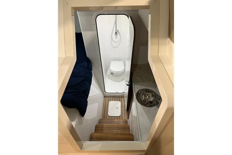 Slide: The Image of Interior of 2026 Front Runner 43 HTX Catamaran featuring compact bathroom and wooden steps. - 9