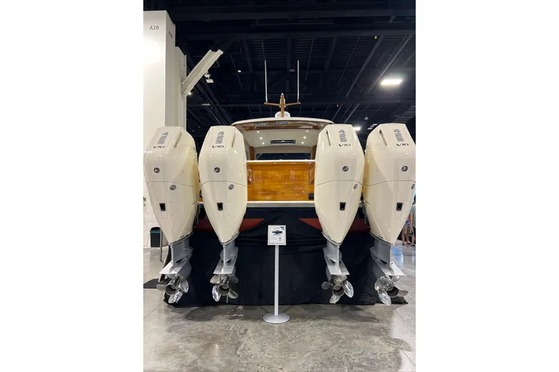 Slide: The Image of 2026 Front Runner 43 HTX Catamaran with four powerful outboard engines displayed indoors. - 2