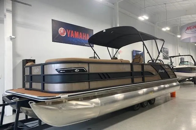 Slide: The Image of 2026 Bentley Pontoons Elite 253 Swingback in showroom, featuring sleek design and Yamaha branding. - 0