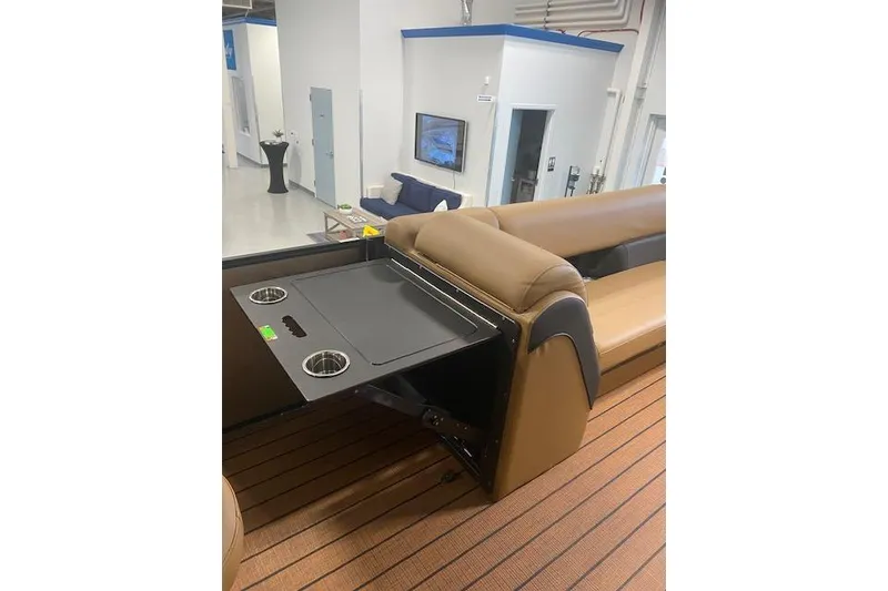 Slide: The Image of 2026 Bentley Pontoons Elite 253 Swingback interior with tan seating and built-in cup holders. - 16