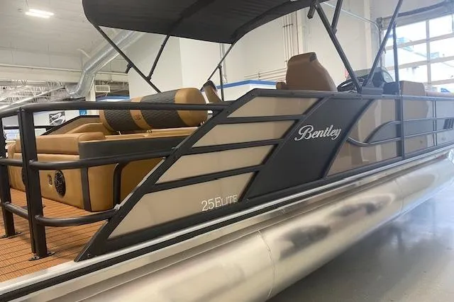 Slide: The Image of 2026 Bentley Pontoons Elite 253 Swingback in showroom, showcasing luxury design and features. - 3