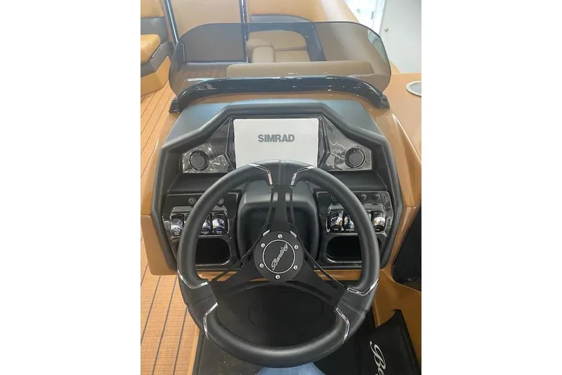 Slide: The Image of 2026 Bentley Pontoons Elite 253 Swingback dashboard with Simrad display and steering wheel. - 9