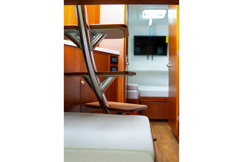 Slide: The Image of Interior of 2026 Front Runner 47 W/A boat with wooden stairs and modern cabin. - 11
