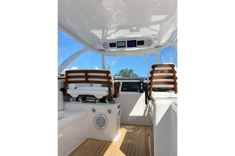 Slide: The Image of Interior of 2026 Front Runner 47 W/A boat with wooden seating and modern controls. - 5