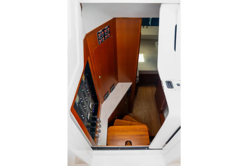 Slide: The Image of Interior view of 2026 Front Runner 47 W/A boat, featuring wooden stairs and control panels. - 10