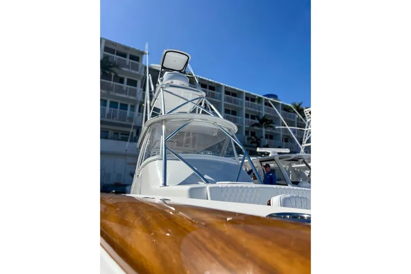 Slide: The Image of 2026 Front Runner 47 W/A boat docked near a building under clear blue sky. - 6