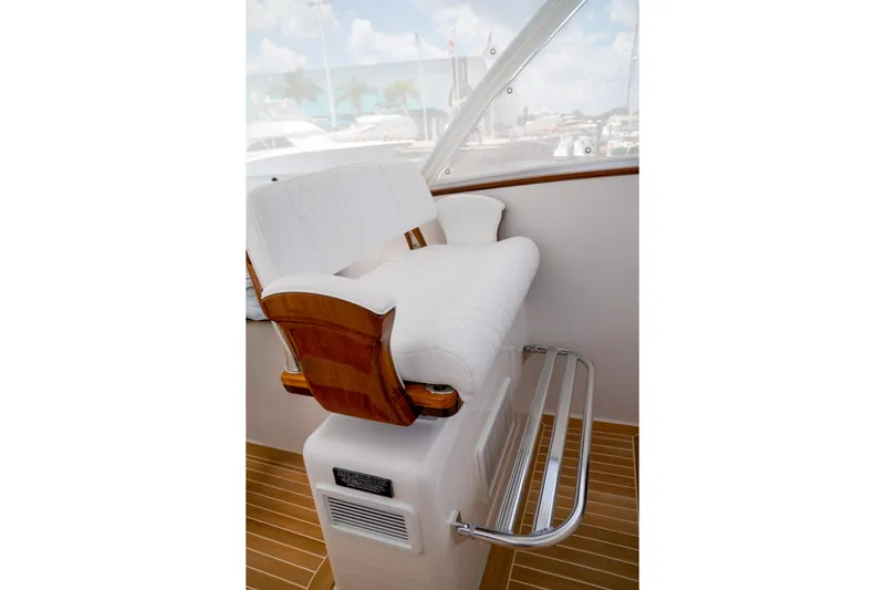 Slide: The Image of Luxury seating on 2026 Front Runner 47 W/A boat, featuring white upholstery and wooden accents. - 7