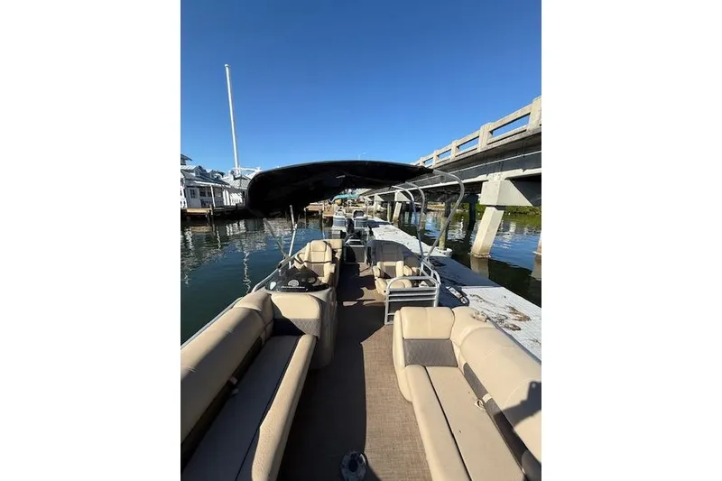 Slide: The Image of 2023 Sun Tracker Party Barge 22 DLX pontoon boat docked by a bridge. - 49