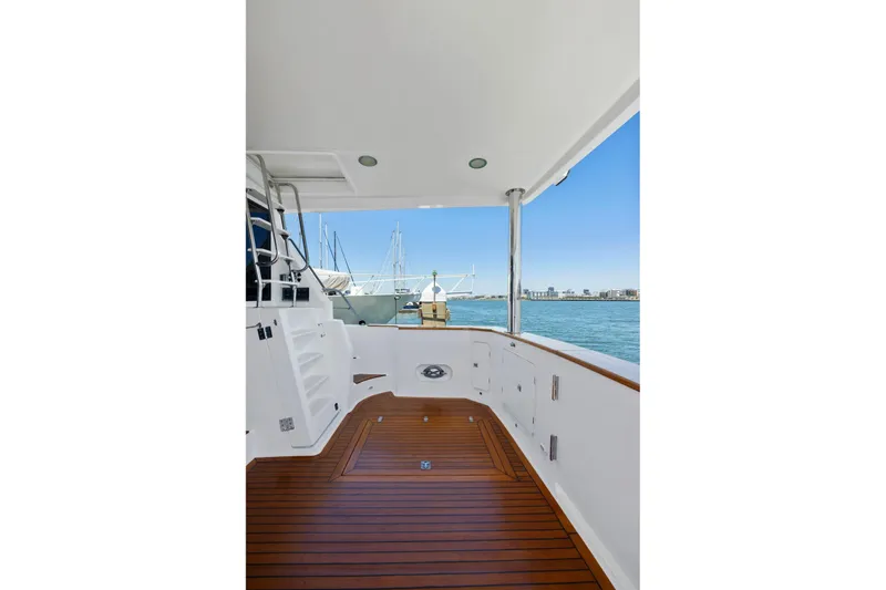 Slide: The Image of Spacious deck of 1999 Symbol 558 yacht with wooden flooring and ocean view. - 11