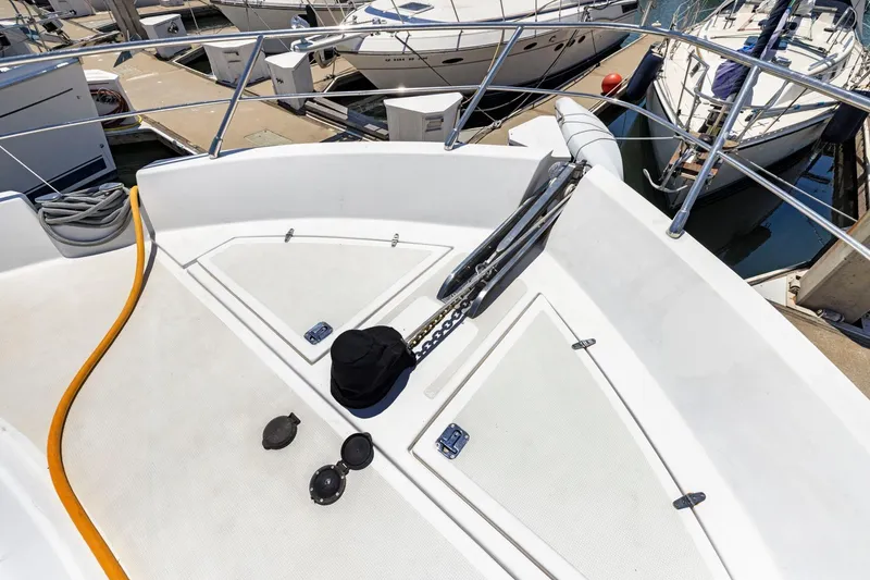 Slide: The Image of Bow of a 1999 Symbol 558 yacht docked at a marina. - 19