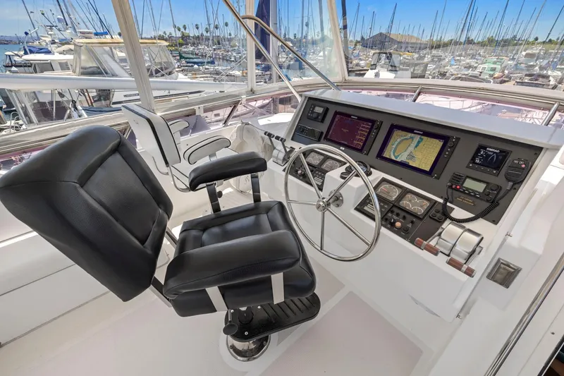 Slide: The Image of Helm of 1999 Symbol 558 yacht with navigation screens and leather chair. - 23