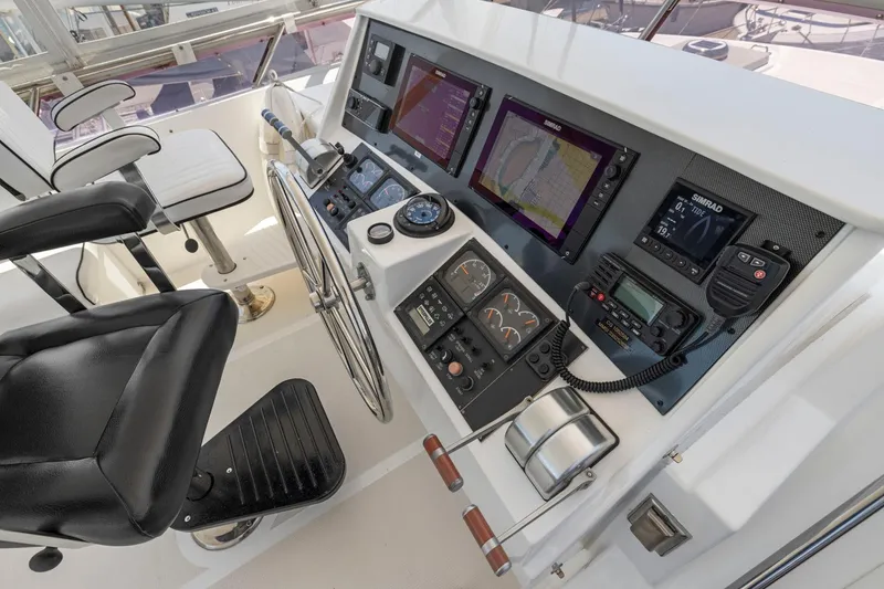 Slide: The Image of Boat helm with navigation screens and controls, Symbol 558, 1999 model. - 24