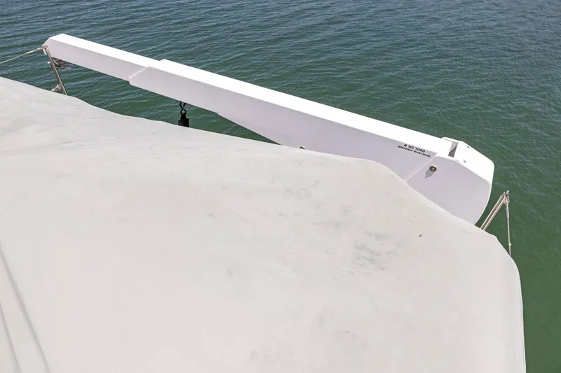 Slide: The Image of White boat deck with crane arm over water, Symbol 558, 1999 model. - 27