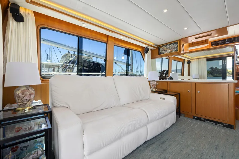 Slide: The Image of Luxurious interior of a 1999 Symbol 558 yacht with white sofa and wooden accents. - 30