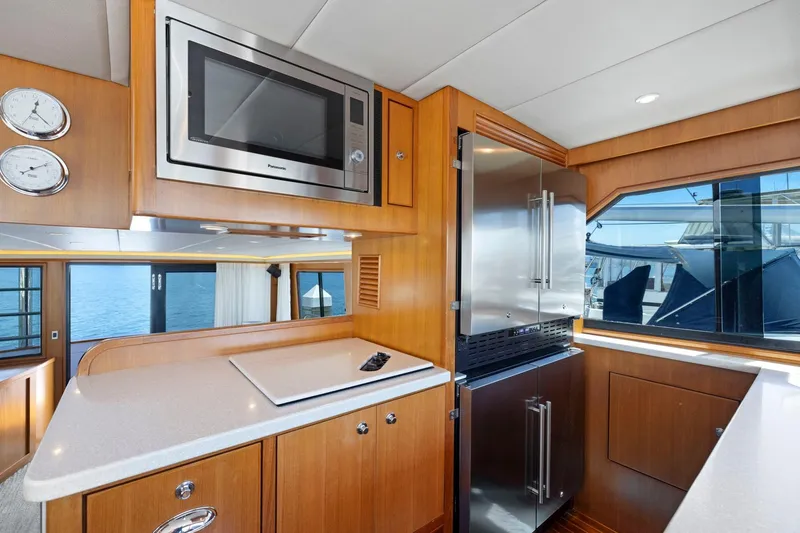 Slide: The Image of Luxurious yacht kitchen interior with modern appliances, wood cabinetry, and ocean view. Symbol 558, 1999. - 44