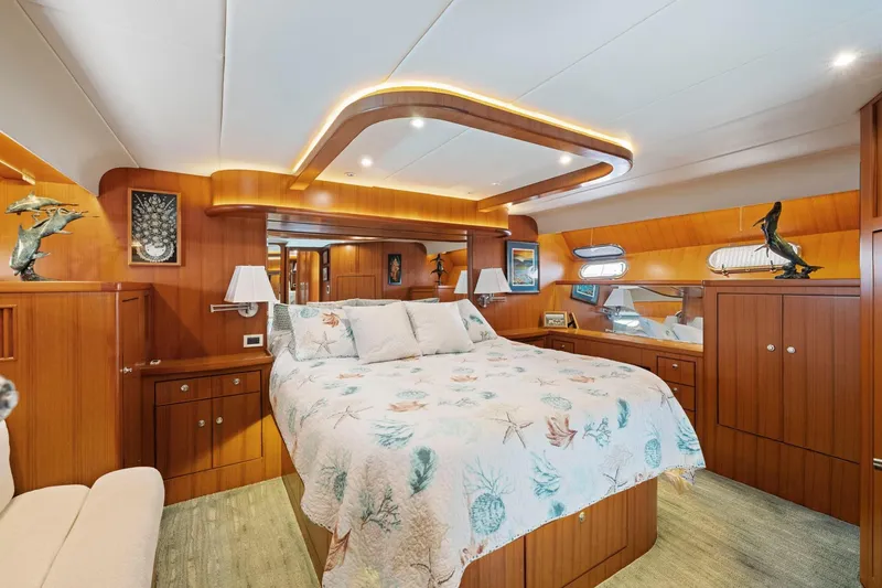 Slide: The Image of Luxurious yacht bedroom with wood paneling, decorative lighting, and nautical-themed bedding. Symbol 558, 1999. - 48