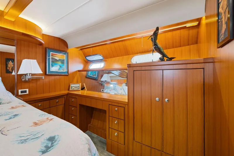 Slide: The Image of Luxurious wooden interior of a 1999 Symbol 558 yacht cabin with elegant decor. - 51