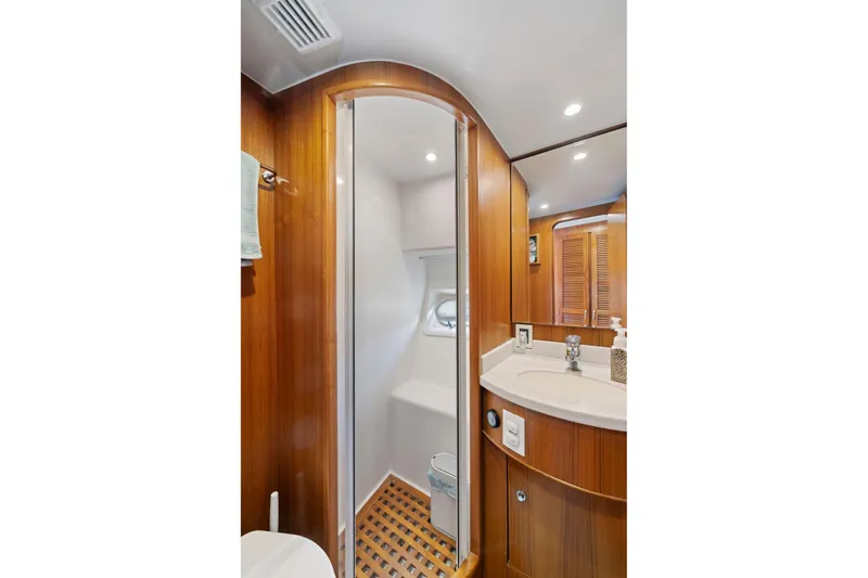 Slide: The Image of Luxurious yacht bathroom with wood accents, shower, and vanity, Symbol 558, 1999 model. - 57