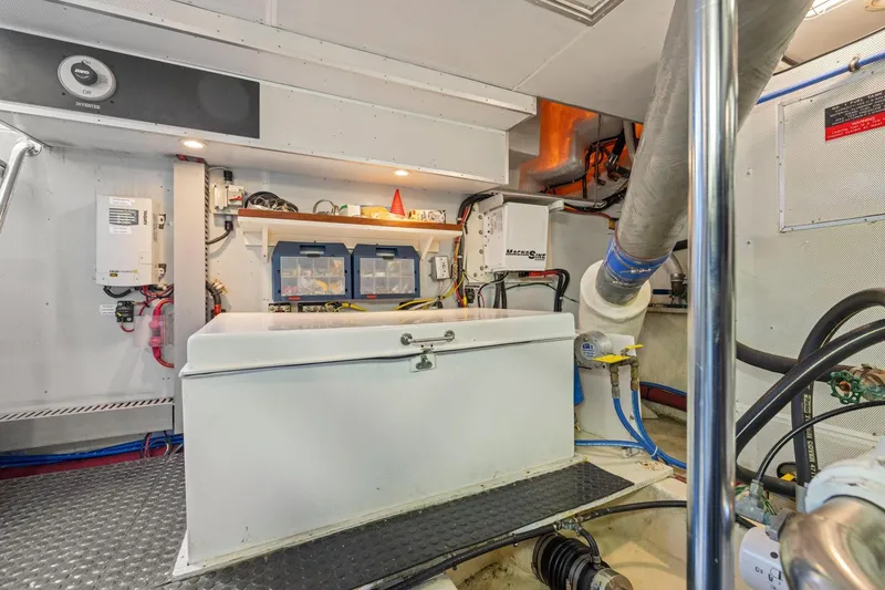 Slide: The Image of Engine room of a 1999 Symbol 558 yacht with equipment and storage. - 64