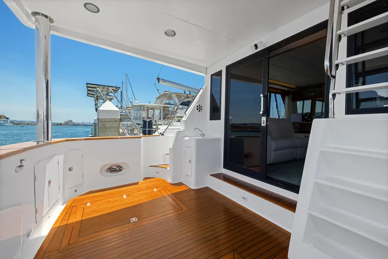 Slide: The Image of Luxurious 1999 Symbol 558 yacht deck with teak flooring and marina view. - 8