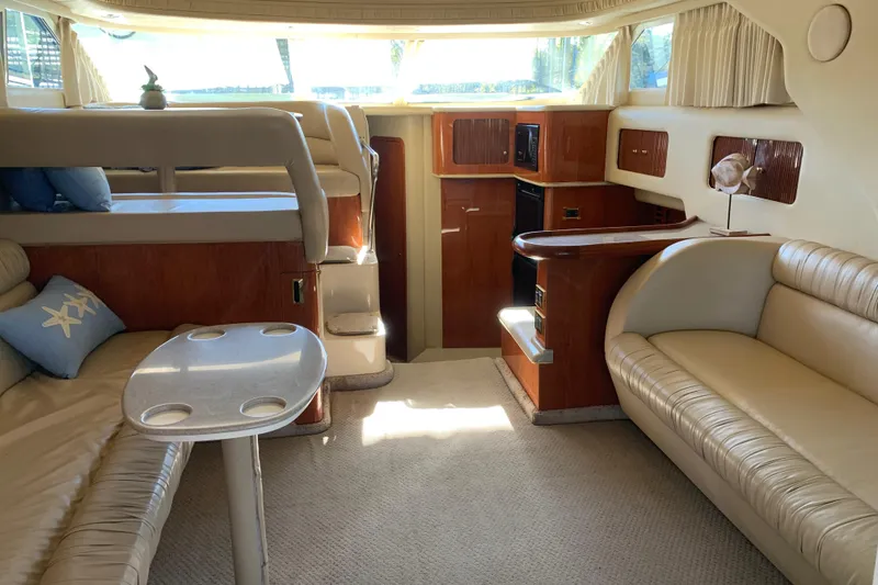 Slide: The Image of Luxurious interior of a 2000 Sea Ray 400 Sedan Bridge yacht with elegant seating and wood finishes. - 10
