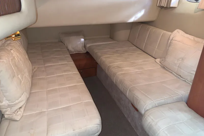 Slide: The Image of Interior cabin of 2000 Sea Ray 400 Sedan Bridge with twin beds and cushions. - 13