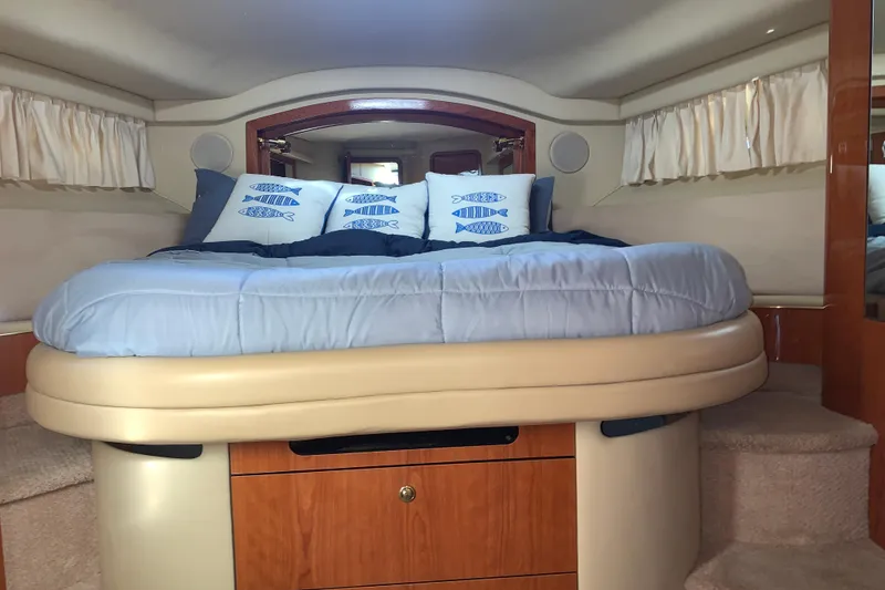 Slide: The Image of Cozy bedroom in 2000 Sea Ray 400 Sedan Bridge yacht with nautical-themed pillows. - 14