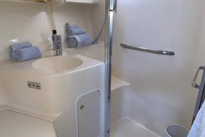 Slide: The Image of Luxurious bathroom in 2000 Sea Ray 400 Sedan Bridge yacht with sink and shower. - 16
