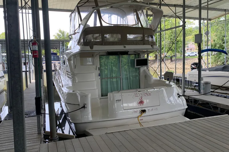Slide: The Image of 2000 Sea Ray 400 Sedan Bridge yacht docked in a covered marina. - 3