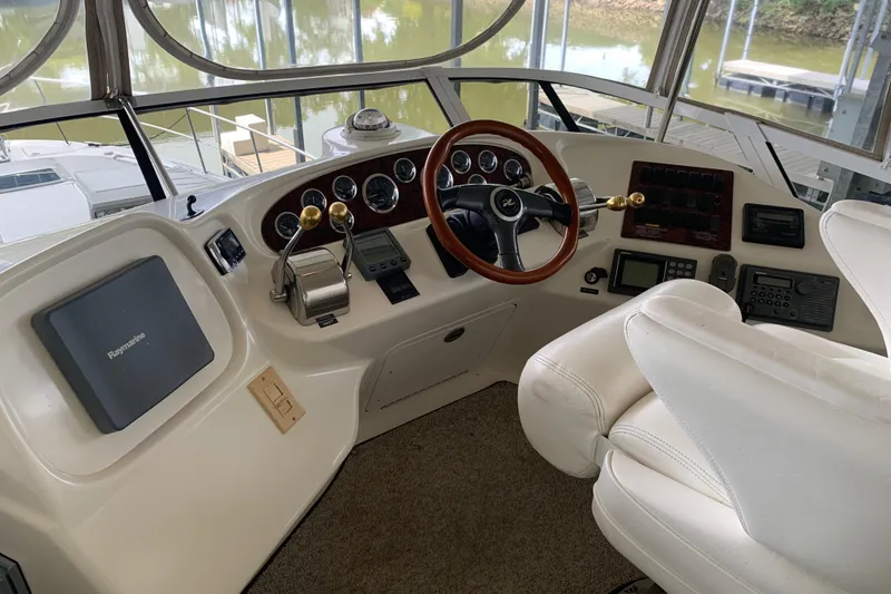 Slide: The Image of Cockpit of 2000 Sea Ray 400 Sedan Bridge with steering wheel and navigation controls. - 6