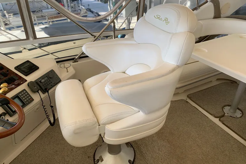 Slide: The Image of Captain's chair on 2000 Sea Ray 400 Sedan Bridge yacht, featuring helm controls and luxurious seating. - 7
