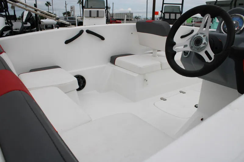 Slide: The Image of 2022 Tahoe T16 boat interior with white seating and steering wheel. - 5
