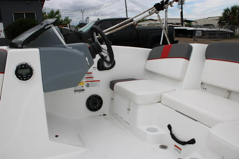 Slide: The Image of 2022 Tahoe T16 boat interior with steering wheel and seating area. - 8