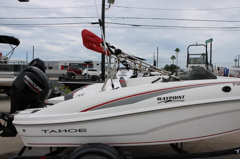 Slide: The Image of 2022 Tahoe T16 boat with Mercury engine on trailer, parked outdoors. - 9