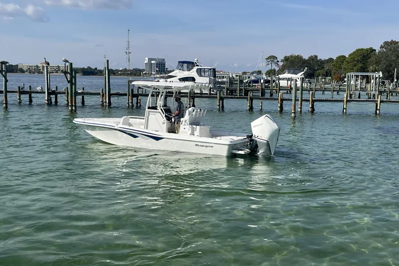 Slide: The Image of 2026 Ranger 2510 Bay boat on clear water near a dock. - 17