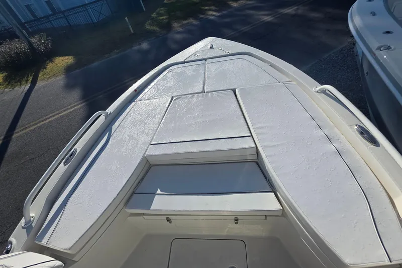 Slide: The Image of 2026 Ranger 2510 Bay boat displayed outdoors with palm trees in the background. - 4