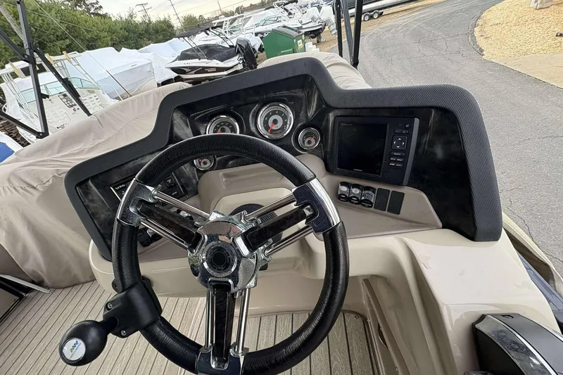 Slide: The Image of Steering console of 2018 Avalon 2385 EL boat with gauges and controls. - 14