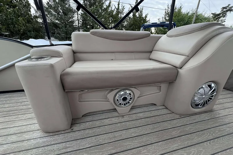 Slide: The Image of Luxurious seating on 2018 Avalon 2385 EL boat with integrated speakers and cup holder. - 20