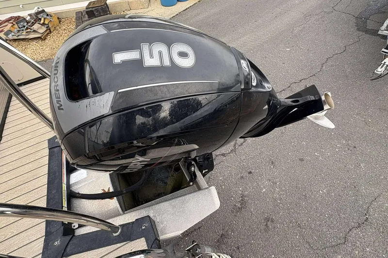 Slide: The Image of 2018 Avalon 2385 EL with Mercury 150 outboard motor on a trailer. - 23