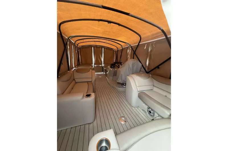 Slide: The Image of 2018 Avalon 2385 EL pontoon boat interior with beige seating and canopy. - 29