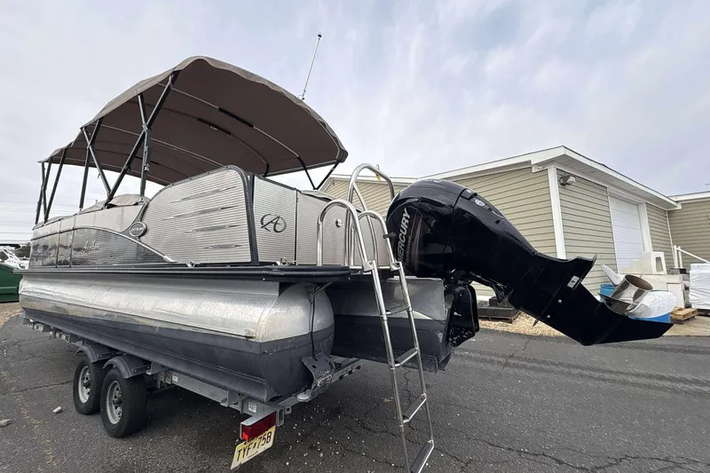 Slide: The Image of 2018 Avalon 2385 EL pontoon boat with Mercury outboard motor on trailer. - 4