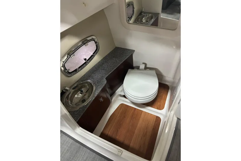 Slide: The Image of 2017 Chaparral 257 SSX boat bathroom with sink, toilet, and wood flooring. - 20
