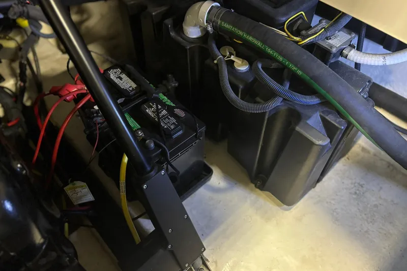 Slide: The Image of Engine compartment of 2017 Chaparral 257 SSX showing battery and wiring components. - 23