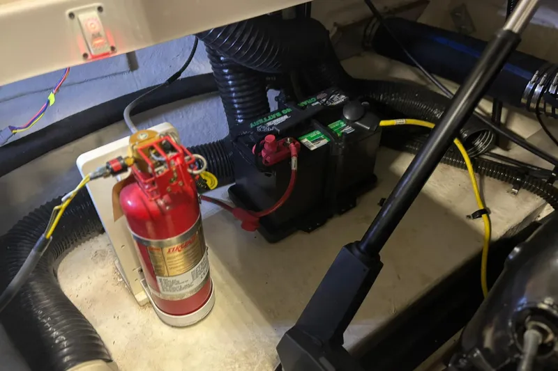 Slide: The Image of 2017 Chaparral 257 SSX engine compartment with fire extinguisher and battery setup. - 24