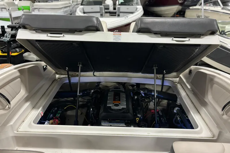 Slide: The Image of 2017 Chaparral 257 SSX boat engine compartment with open hatch, showcasing engine details. - 27