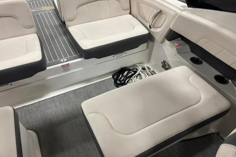 Slide: The Image of 2017 Chaparral 257 SSX boat interior with beige seating and ropes. - 31