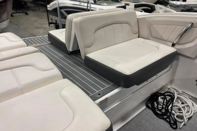 Slide: The Image of 2017 Chaparral 257 SSX boat interior with white seating and coiled ropes. - 33