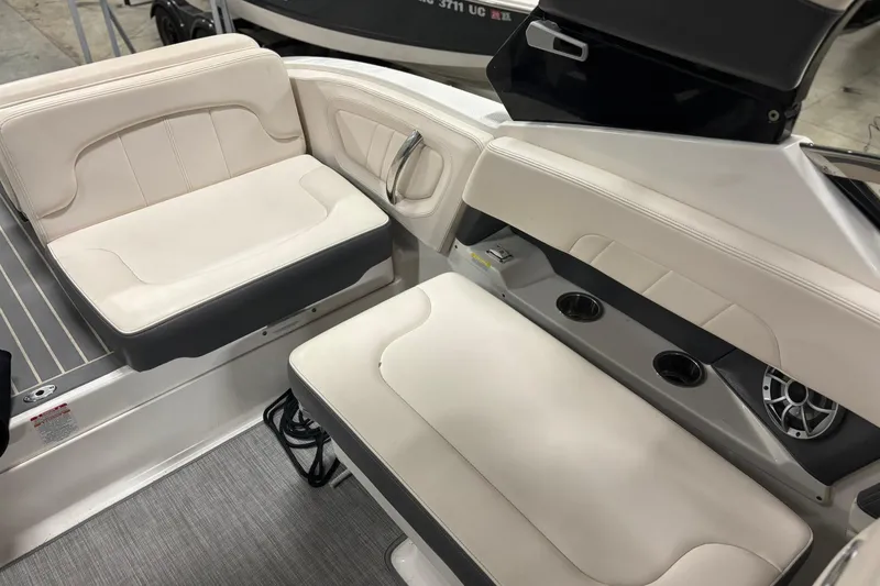 Slide: The Image of 2017 Chaparral 257 SSX boat interior with beige seating and cup holders. - 7