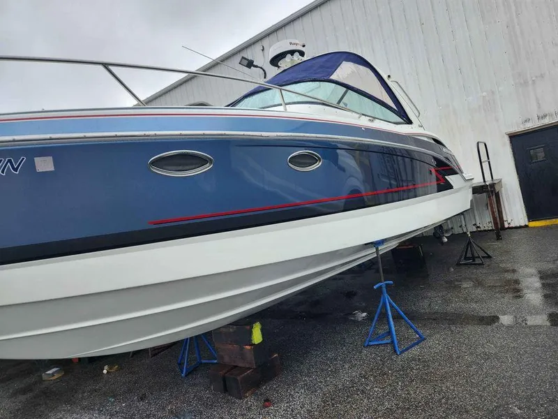 Slide: The Image of 2018 Formula 310 Sun Sport boat on stands outside a white building. - 3